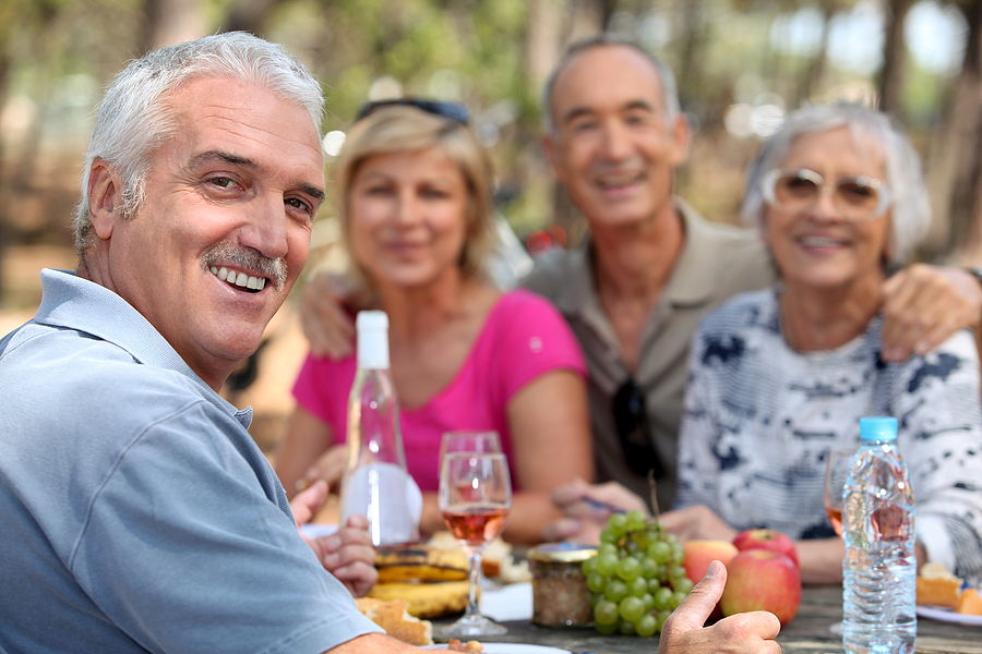 Older adults enjoying lunch outdoors in Lewes, DE