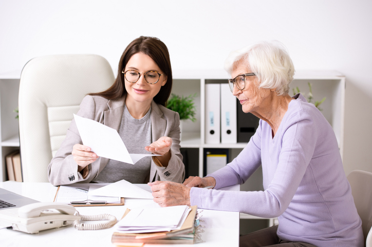 Senior Woman and Admin Reviewing Paperwork
